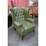 A green leather Chesterfield wingback armchair