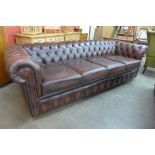 A chestnut brown leather Chesterfield settee, 73cms h, 248cms w, 88cms d