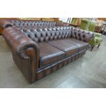 A chestnut brown leather Chesterfield settee, 73cms h, 204cms w, 88cms d