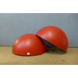 A pair of red enamelled light shades