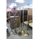 An Islamic black and gilt metal standard lamp and six other brass standard lamps