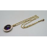 A 14ct gold mounted purple cabochon and paste pendant on a 14ct gold chain, 10.8g