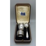 A silver spoon, egg cup and napkin ring, 71g, cased