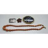 An amber coloured bead necklace, a Siam silver brooch, a Victorian agate set large brooch and a