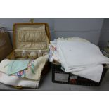 A collection of linen and a travel case **PLEASE NOTE THIS LOT IS NOT ELIGIBLE FOR POSTING AND