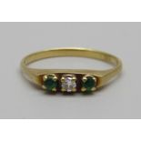 An 18ct diamond and emerald three stone ring, 2.5g, T