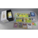 250 Assorted Pokemon cards including Holos, protective sleeve packs, dice and coins