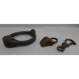 A shackle bearing inscription, a dog clip and a padlock