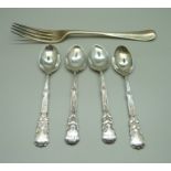 A silver fork and a set of four silver spoons with golf detail, 157g
