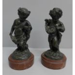 A pair of bronze putti on marble bases, 20cm