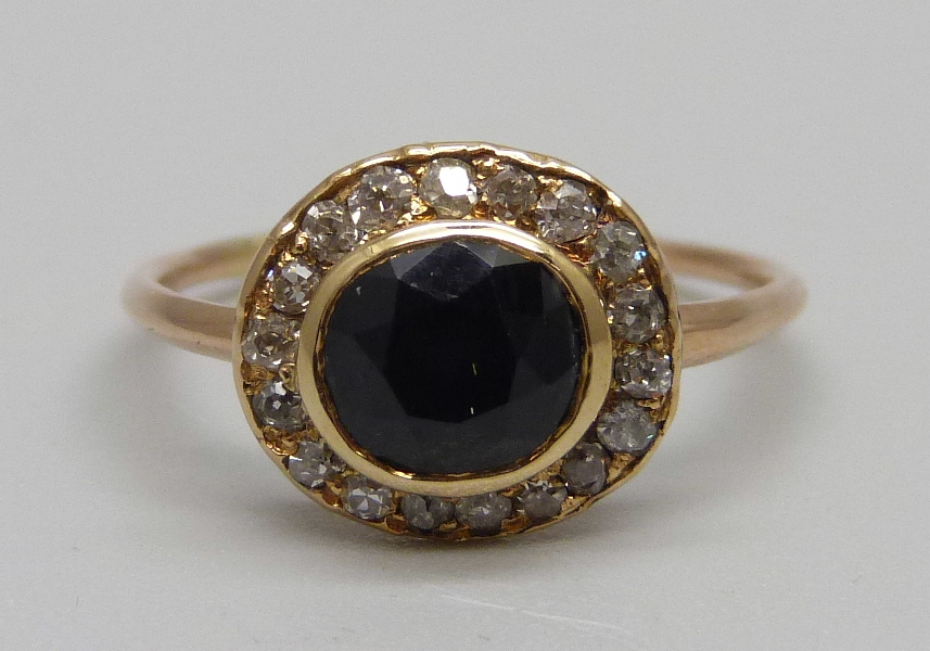 A Georgian sapphire and diamond cluster ring, tests as gold, 2.1g, M, ring back bears inscription