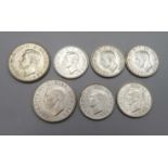 Seven coins; two 2 shillings 1944 and 1945 and five shillings, 1939, three 1943 and 1945, extra fine