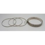 Four silver bangles, one waxed filled, 33g