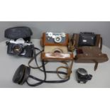 A collection of three cameras and a meter, includes Argus Cintar and Asahi Pentax