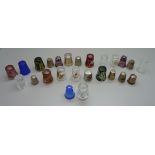 A collection of thimbles, including seven silver, Bohemian glass and three millefiori