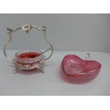 A cranberry glass heart shaped dish and a cranberry glass preserve pot, stand and spoon (2)