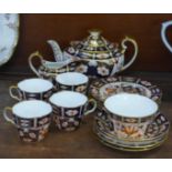 A Royal Crown Derby 2451 four setting tea set with tea pot, cream and sugar bowl