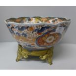 An Oriental bowl on gilt metal stand, bowl a/f, 30cm