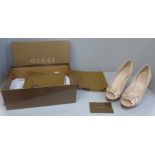 A pair of lady's Gucci shoes, cream leather with wooden sole and heel, Gucci buckle, size 36C, boxed