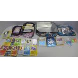 Assorted Pokemon cards with Holos and collector tins