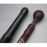 Two carved wooden walking sticks converted from clubs