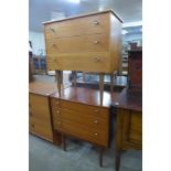 A pair of small teak chests of drawers