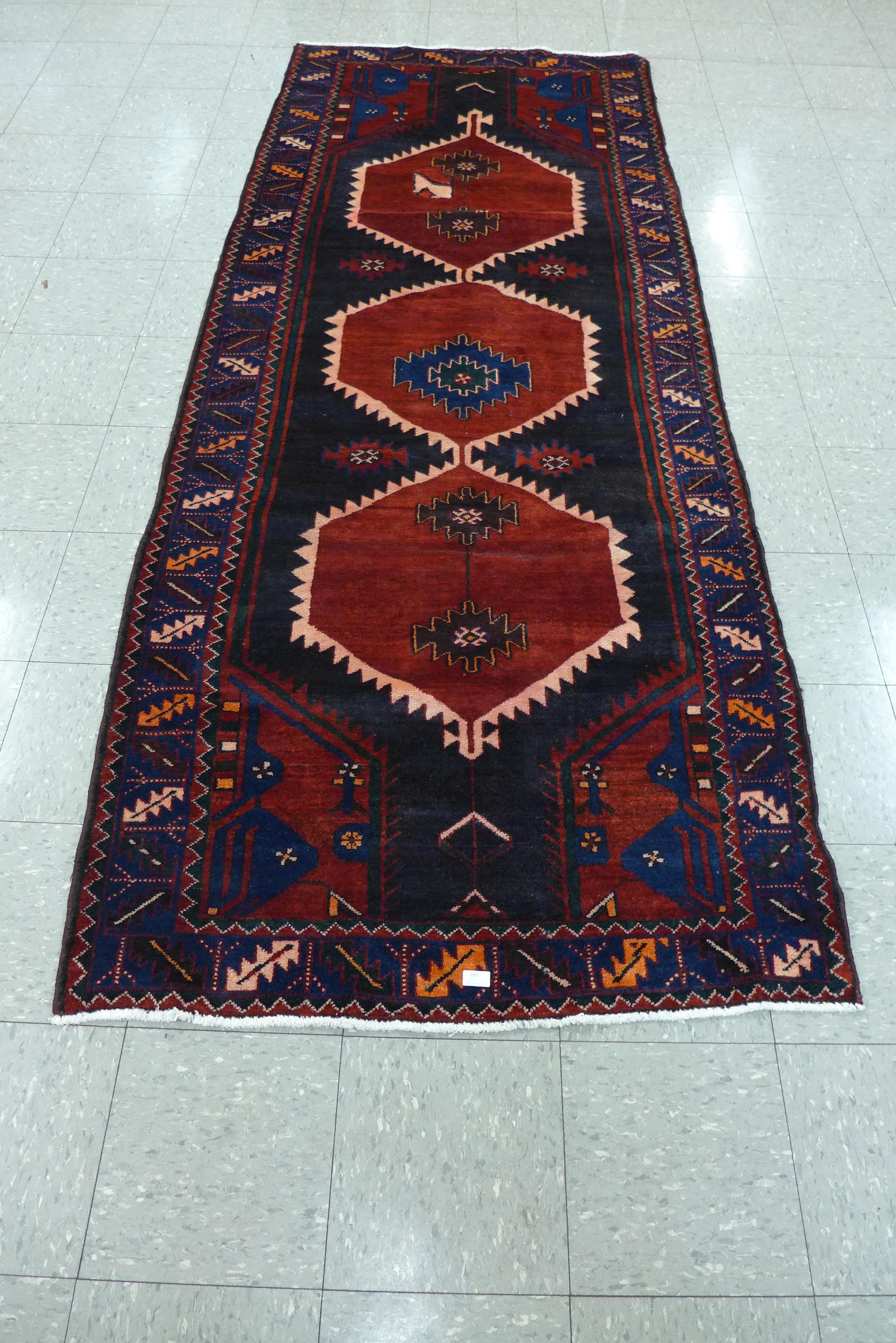 A Persian red ground Hamadan runner rug, 115 x 298cms