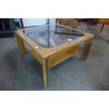 A Nathan teak and glass topped square coffee table