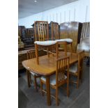 A teak extending dining table and six chairs