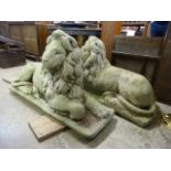 A pair of large concrete garden figures of recumbent lions, 70cms h x 126cms w