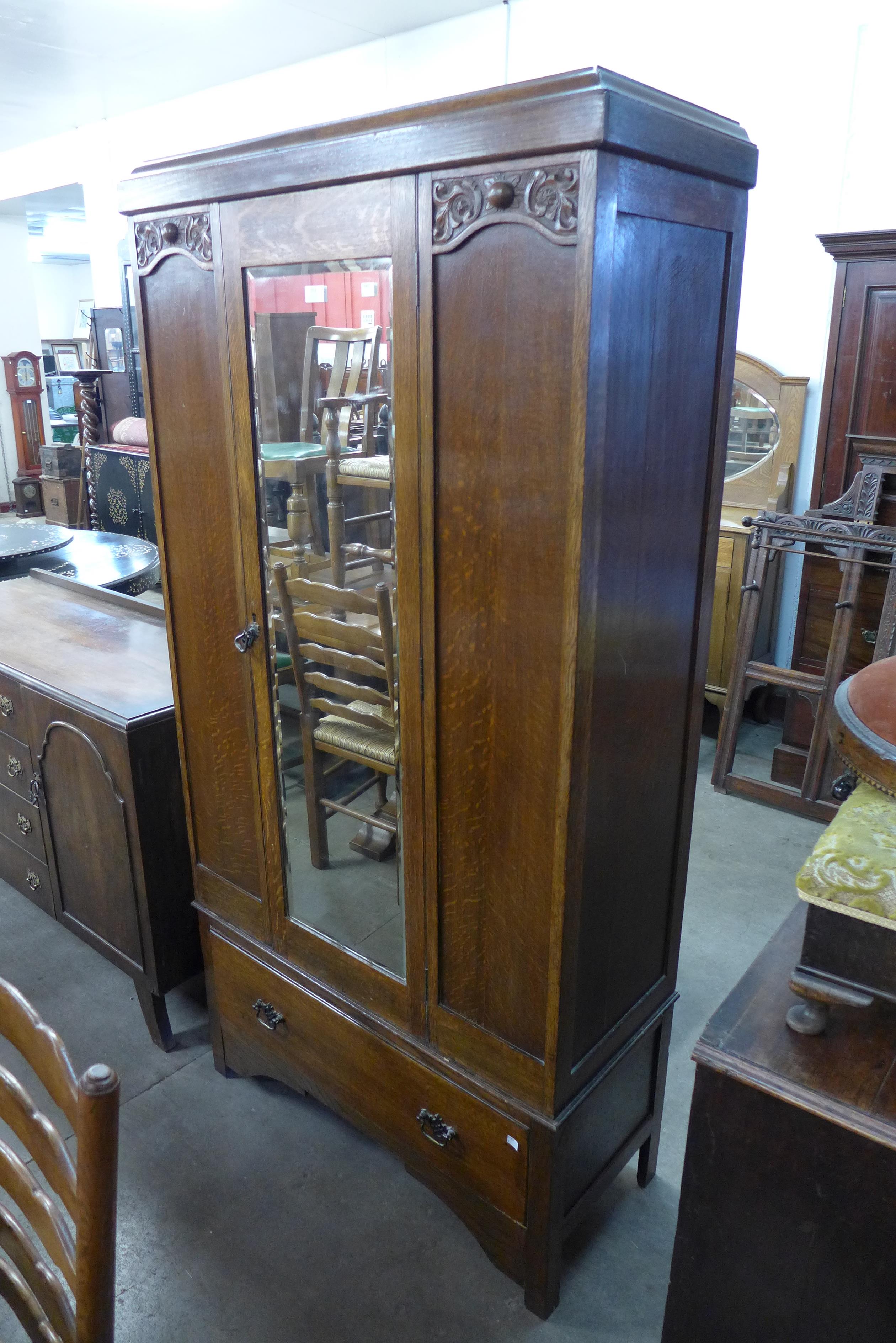 An early 20th Century carved oak wardrobe