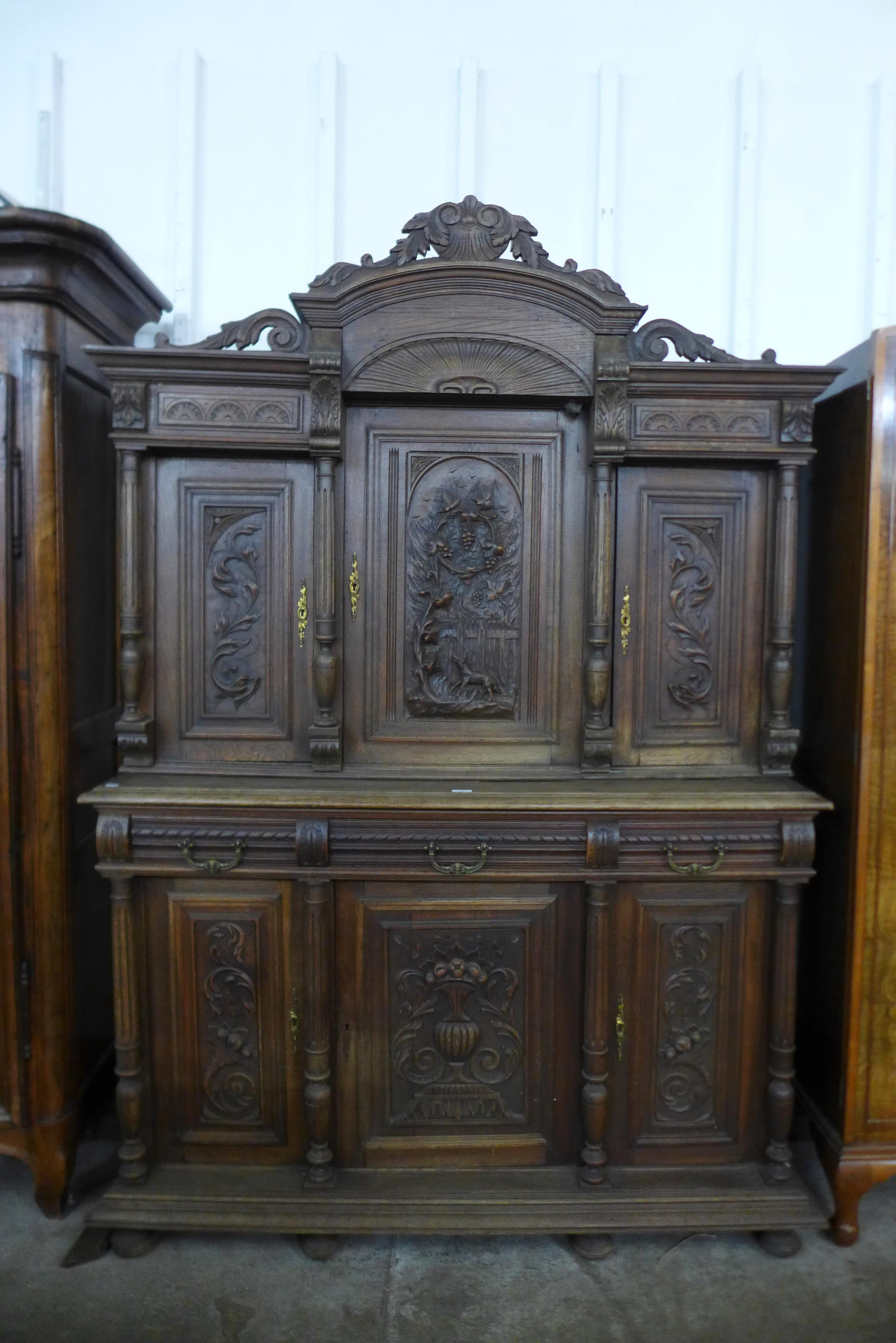 A 19th Century Henry II style carved oak side cabinet