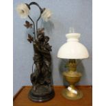 A brass oil lamp and an Art Nouveau style lamp