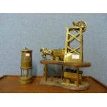 A miner's lamp and a brass colliery model