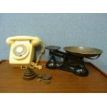 A set of weighing scales and a vintage wall phone