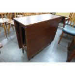 A teak drop leaf table