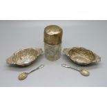 A pair of silver salts with spoons and a silver topped glass bottle, weighable silver 29g