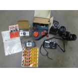 A Nikon 35mm SLR film camera, a pair of Revue 16 x 50 binoculars, three other cameras and booklets