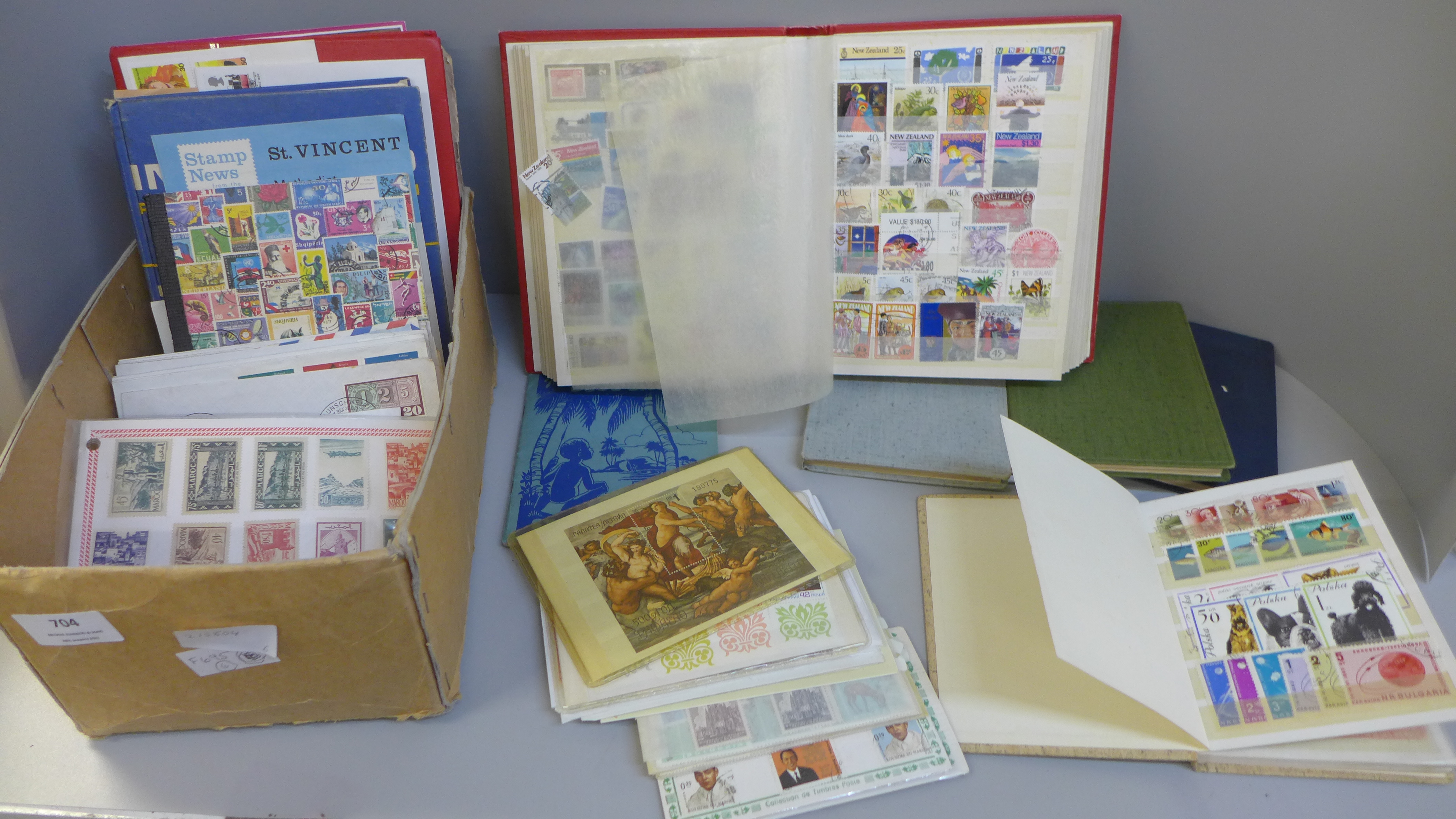 Stamps; a box of stamps in nine medium and small stock books and covers