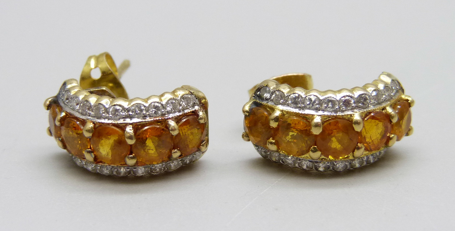 A pair of yellow metal set yellow sapphire and diamond earrings, 4.6g