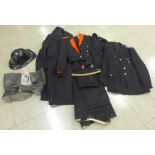 A collection of fire service uniforms, overcoats, boots, helmet, whistles