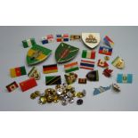 Twenty-six badges including Atlas Editions flags