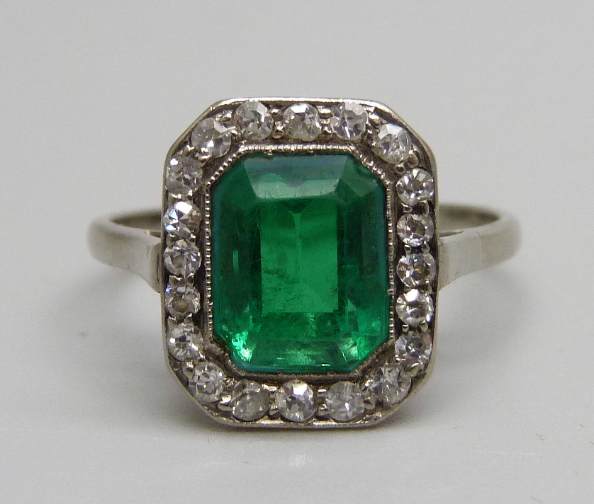 A white metal set Art Deco diamond and green stone ring, green stone a/f (large chip on one corner