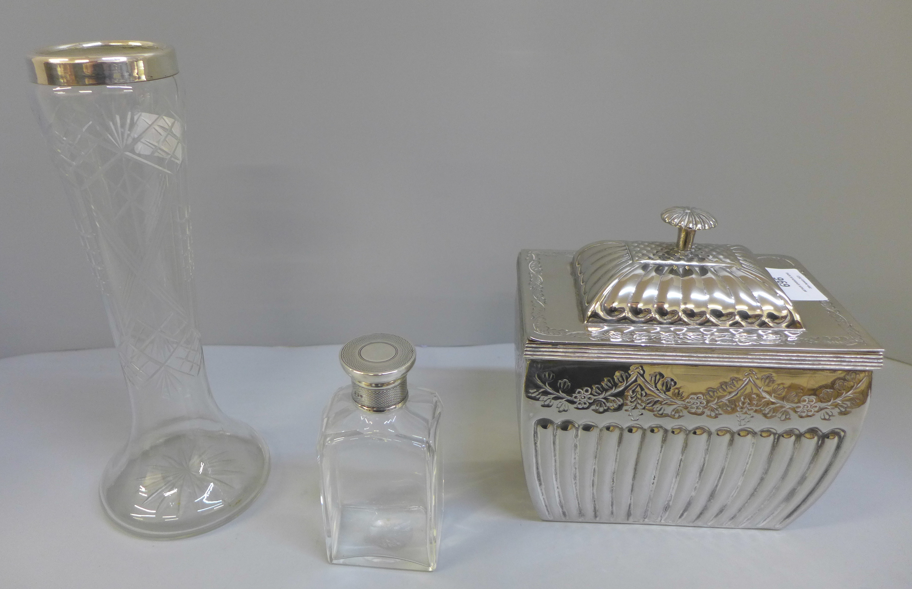 A silver topped jar, silver rimmed vase and a silver plated caddy