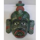 A Guatemalan mask created from resin with jade overlay, 28cm