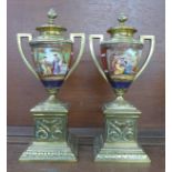 A pair of brass and porcelain garnitures, 23cm