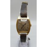 A 9ct gold cased wristwatch, mark worn, case back dented, 24mm case