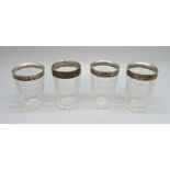 A set of four silver mounted cut glass vodka shots, W. Comyns, London 1899, one base chipped