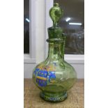 A Bohemian green glass claret jug with enamelled coat of arms