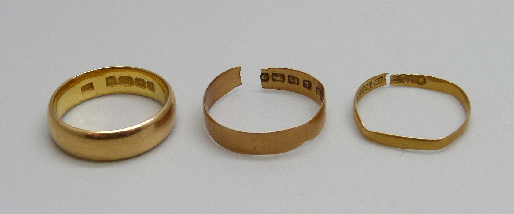 A 22ct gold wedding ring, 6g, M, one other 22ct gold ring, a/f, 0.8g, and an 18ct gold ring, a/f,